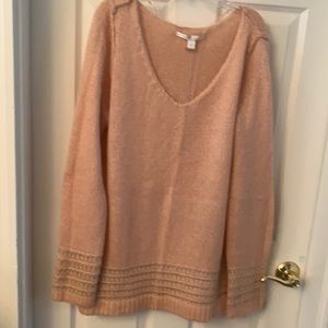 Peachy v-neck sweater with silver on cuffs of sleeve and waist